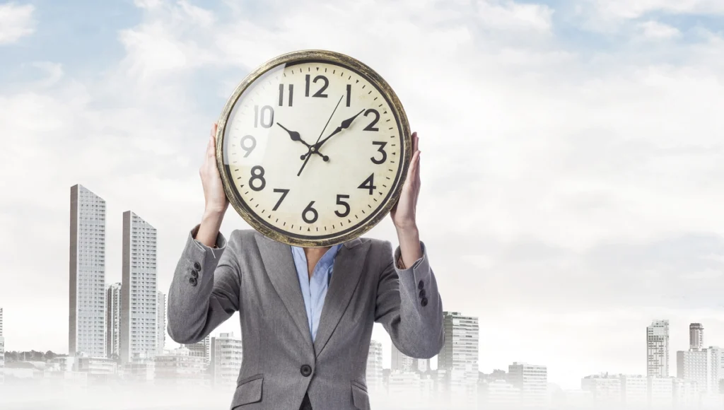 a man with a clock in hands. time management